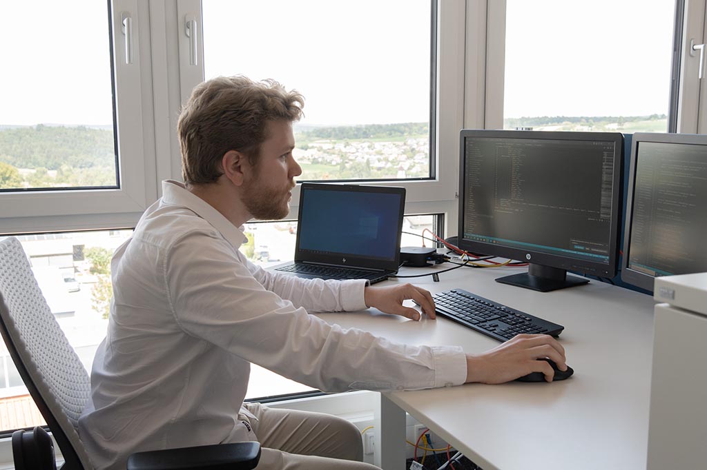 Ilya from STRATEC sitting in front of his desk