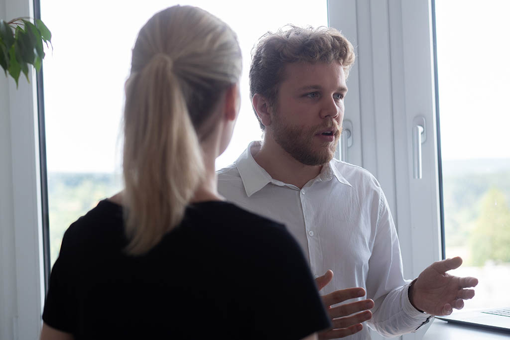 Ilya from STRATEC explaining to someone in the office 
