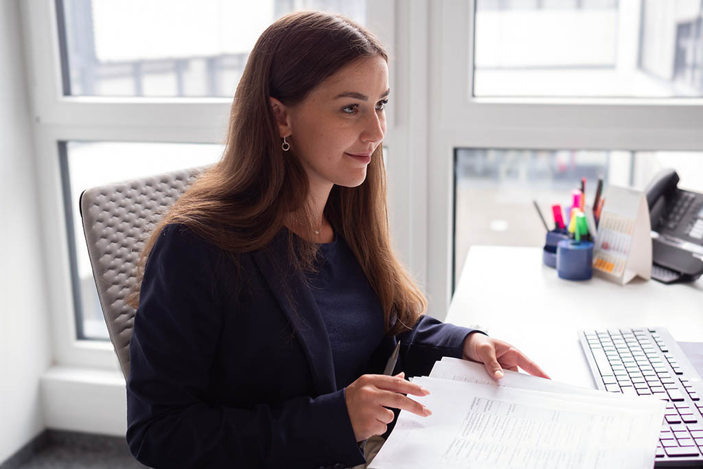Picture of Hanna from STRATEC working on some papers on her desk