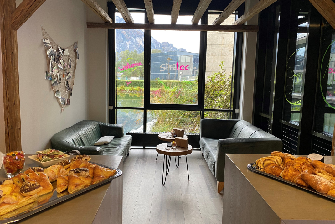 Buffet with pastries in the lounge of our Austrian STRATEC site with outside view