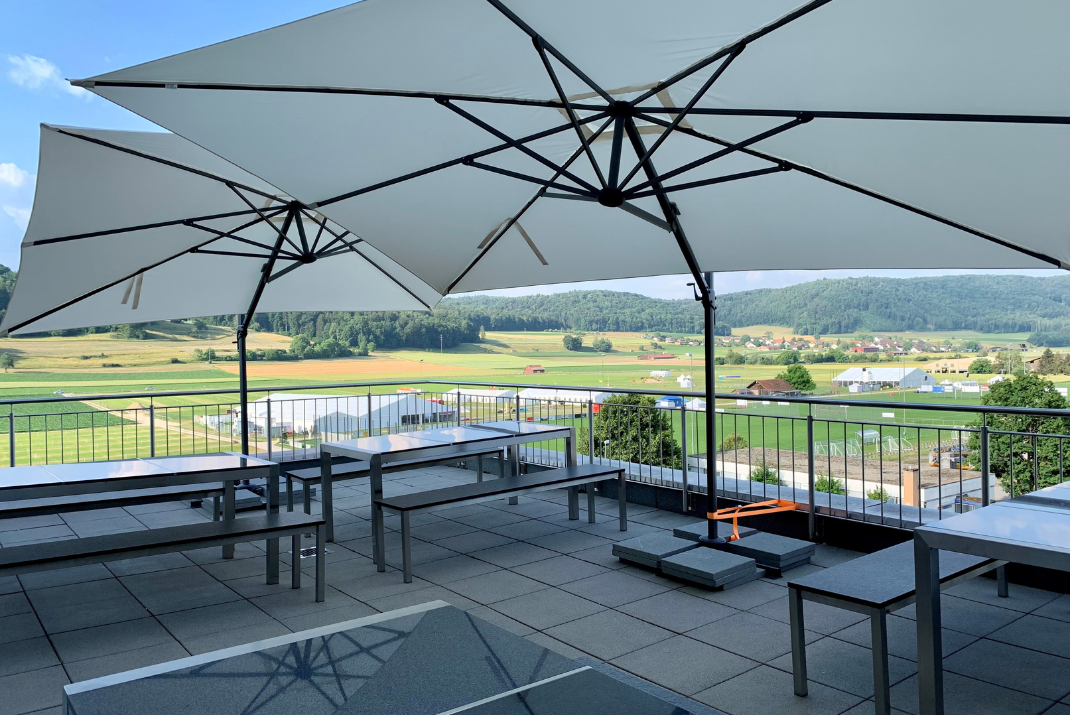 Canteen at the rooftop of our STRATEC site in Beringen, Switzerland with sunshades and fields in the background