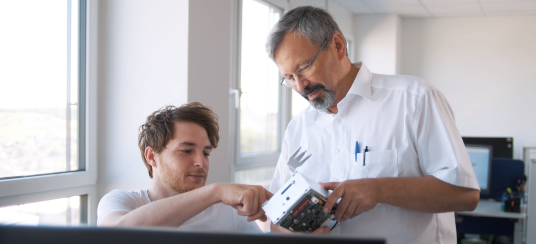 Two STRATEC employees inspecting a module 