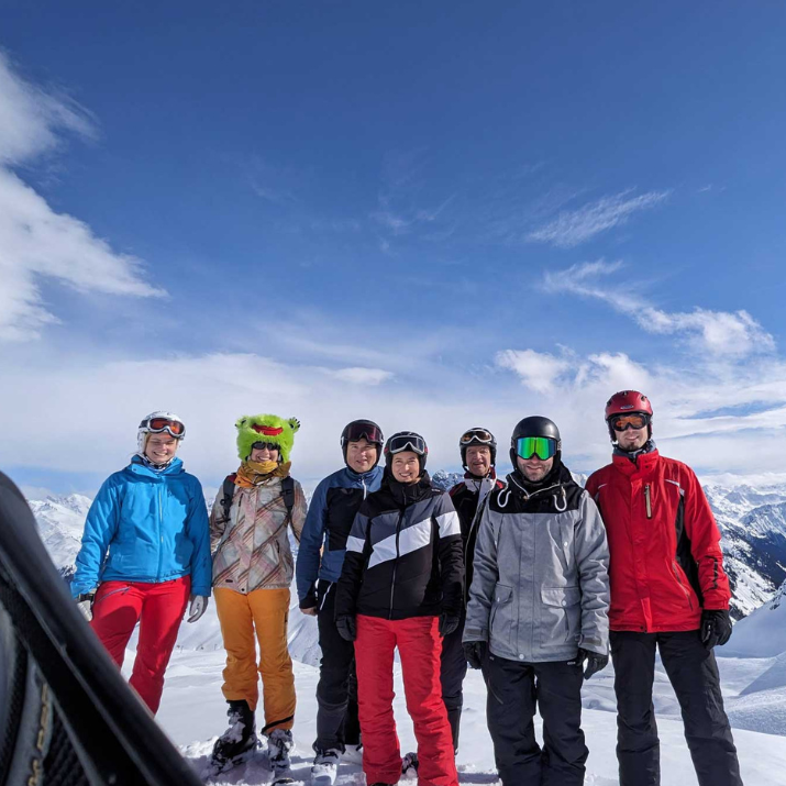 STRATEC employees in a joint skiing vacation posing at the top of the mountain
