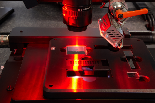 Microscope with a red light in a dark laboratory setting at STRATEC SE