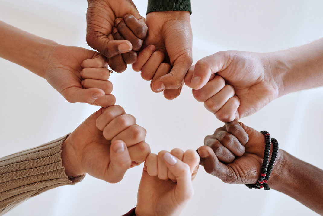 Colleagues’ hands giving each other a fist pump at STRATEC SE