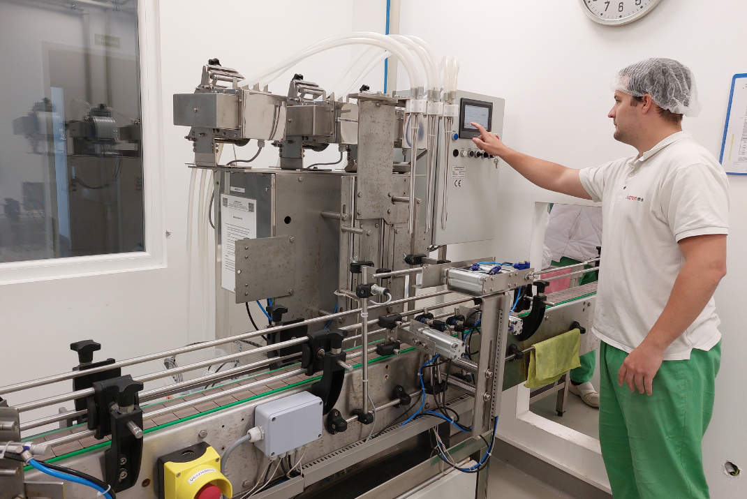 A Diatron employee operates a reagent production machine in Hungary