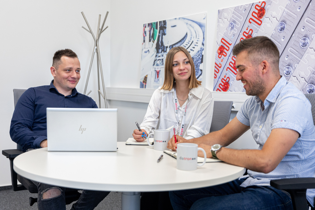 Diatron employees sitting in a round table for a meeting 