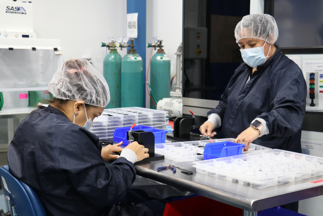 Natech employees with safety hoods and masks preparing the individual components for a Natech system