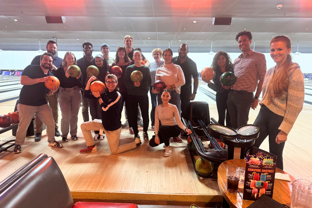 A group selfie of colleagues during a bowling night